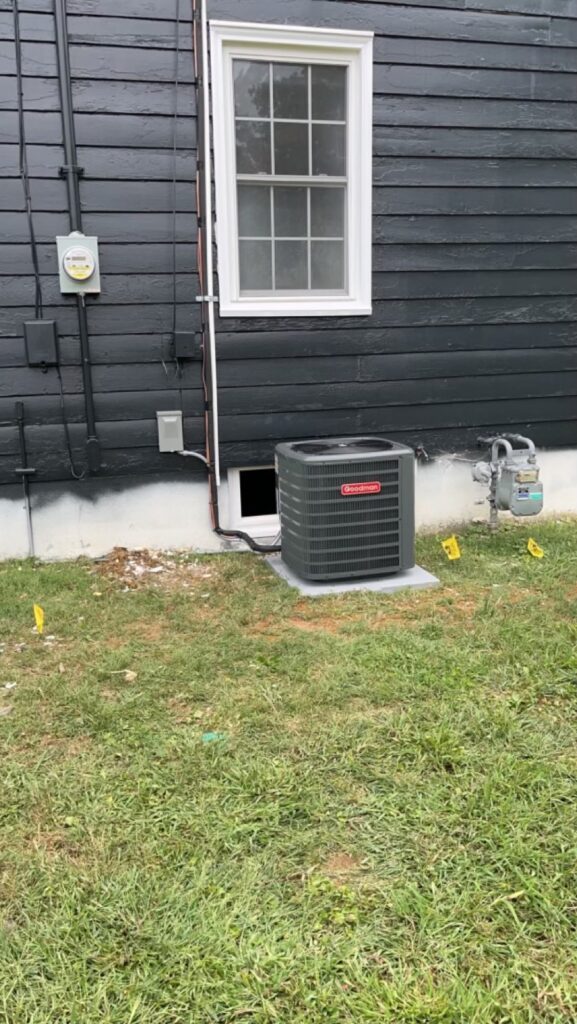 Goodman air conditioning unit installed on a concrete pad at a Louisville home