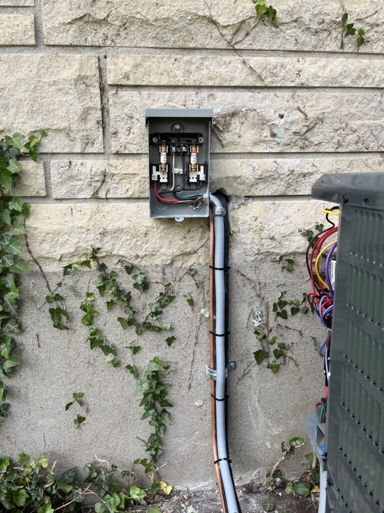 Outdoor electrical disconnect and conduit installed for an AC condenser in Louisville, KY
