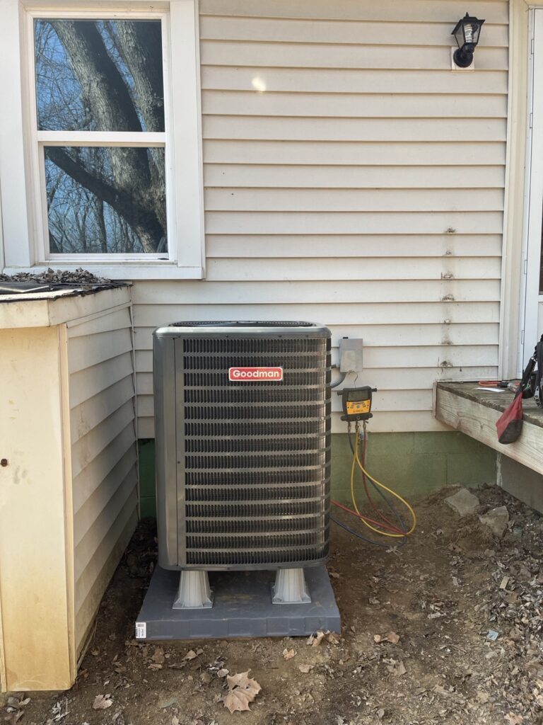 Refrigerant gauges connected to a Goodman AC unit during a maintenance visit in Louisville, KY