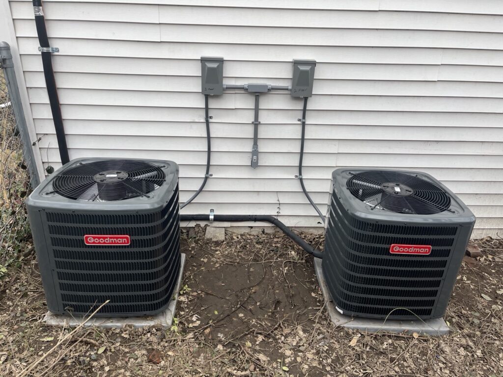 Two Goodman air conditioners serving a two-story rental property in Louisville, KY